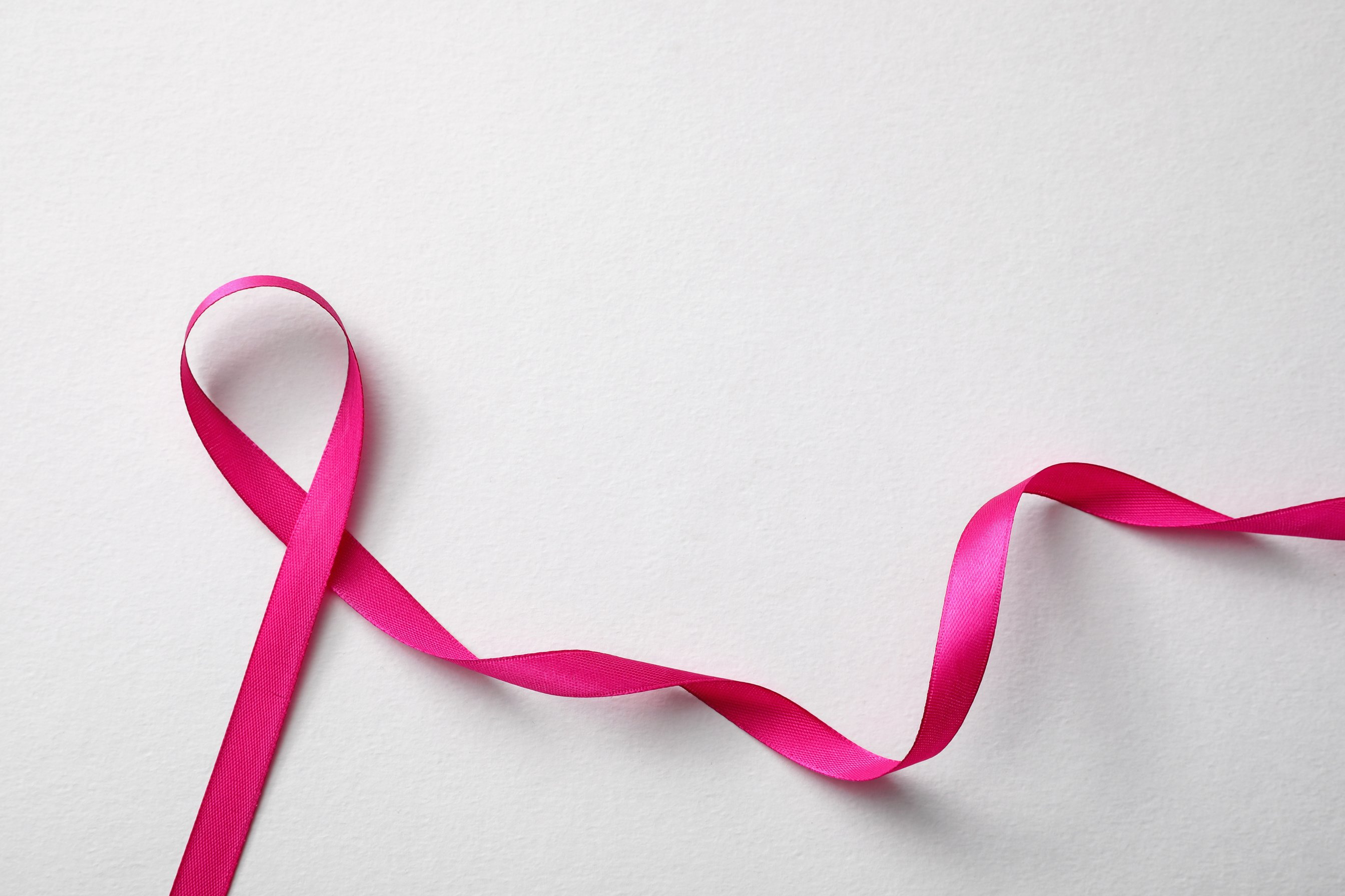 Pink Ribbon on White Background, Top View. Breast Cancer Awarene